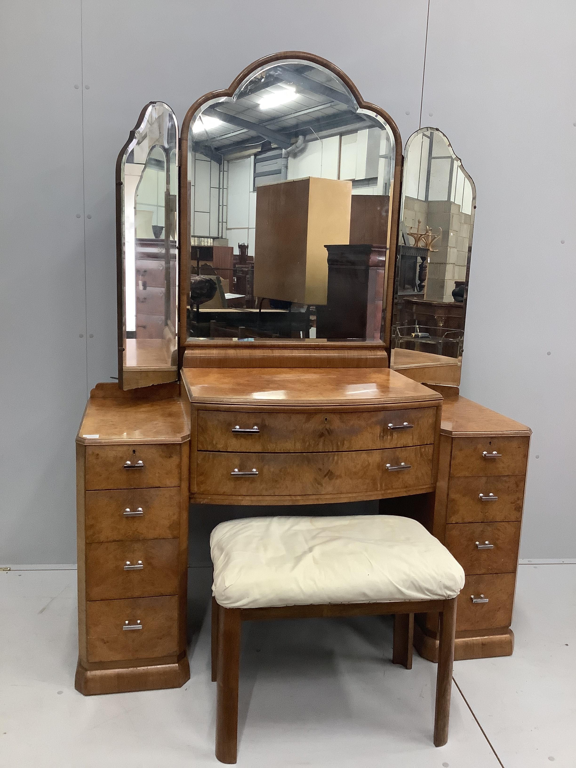 An Art Deco style burr walnut kneehole dressing table, width 136cm, depth 53cm, height 188cm together with a stool